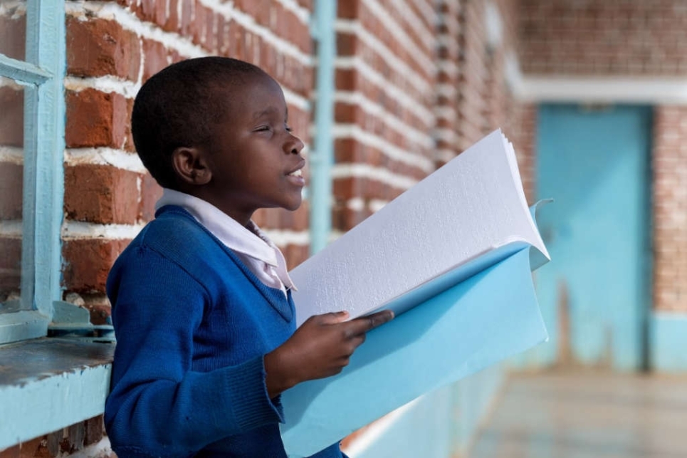 bambino cieco con libro in braille